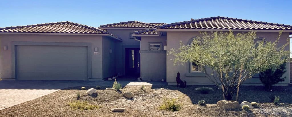Seamless rain gutters installed along the tile roofline of a stucco home in Tucson, Arizona