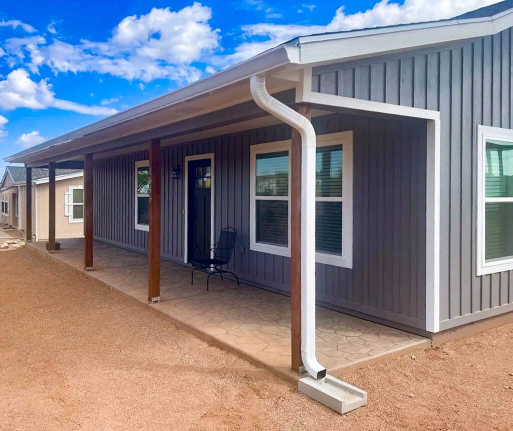 White seamless gutters and downspout on a board and batten home near Tucson, Arizona