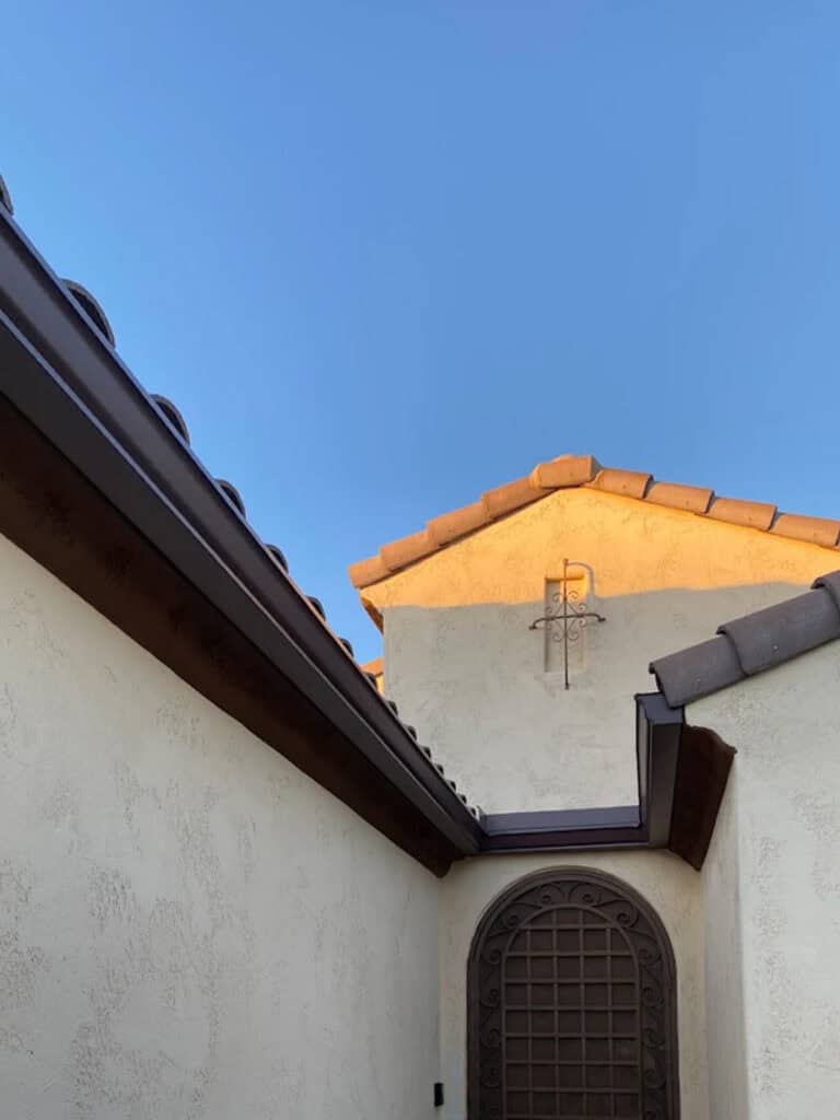 Dark bronze seamless gutters on a white stucco home in Tucson, Arizona