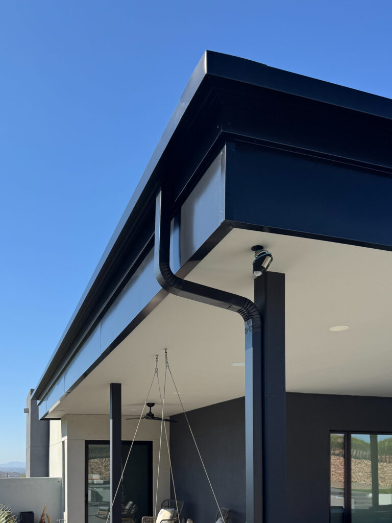 Black aluminum fascia wrap and matching seamless gutter on a modern Tucson, Arizona home